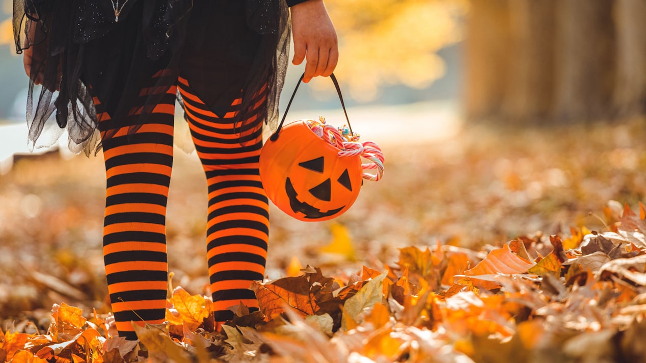 Child in Halloween Gear Holding a Trick-or-Treat Basket