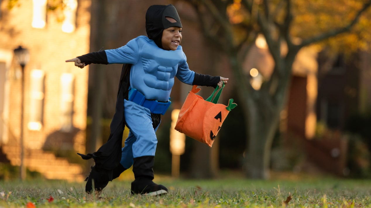 Boy Running While Dressed Up as a Superhero
