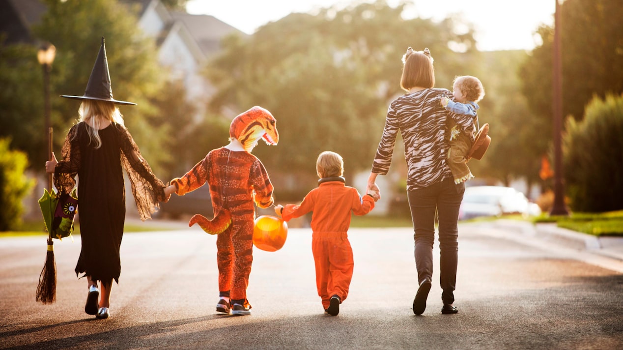 Family Holding Hands Walking Down the Street