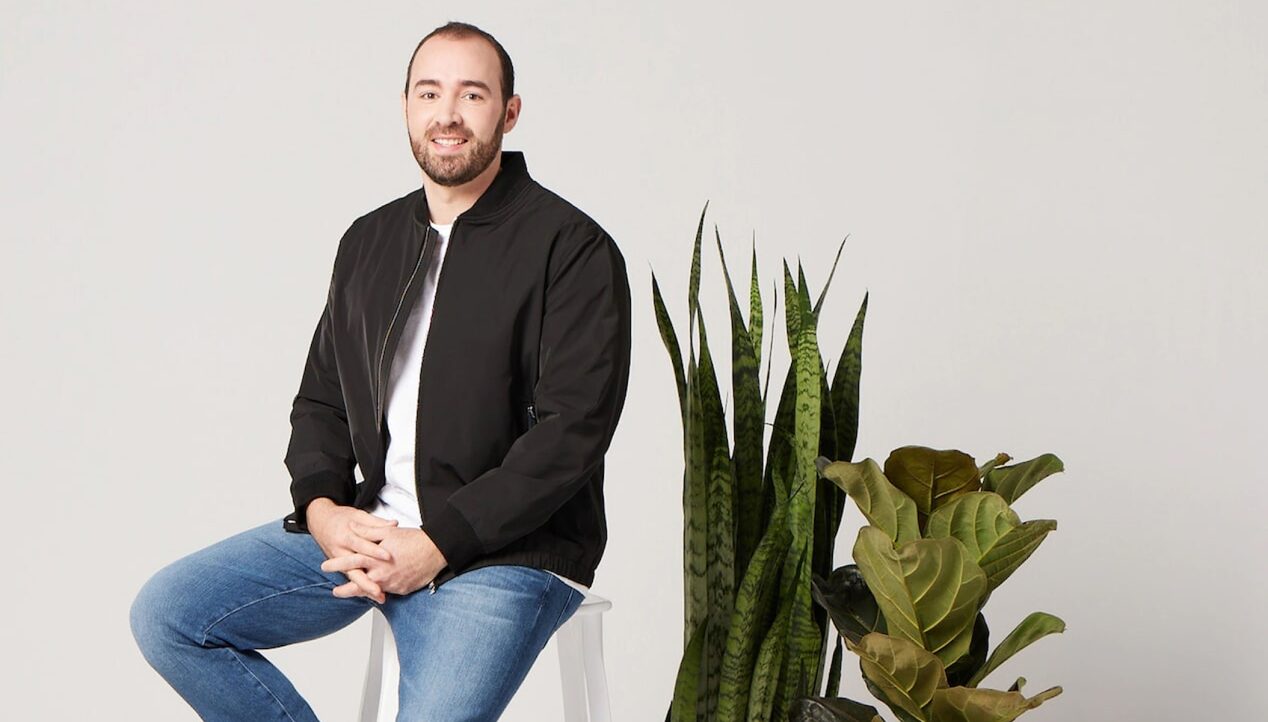 Man Kneeling on a Stool in a Photography Studio