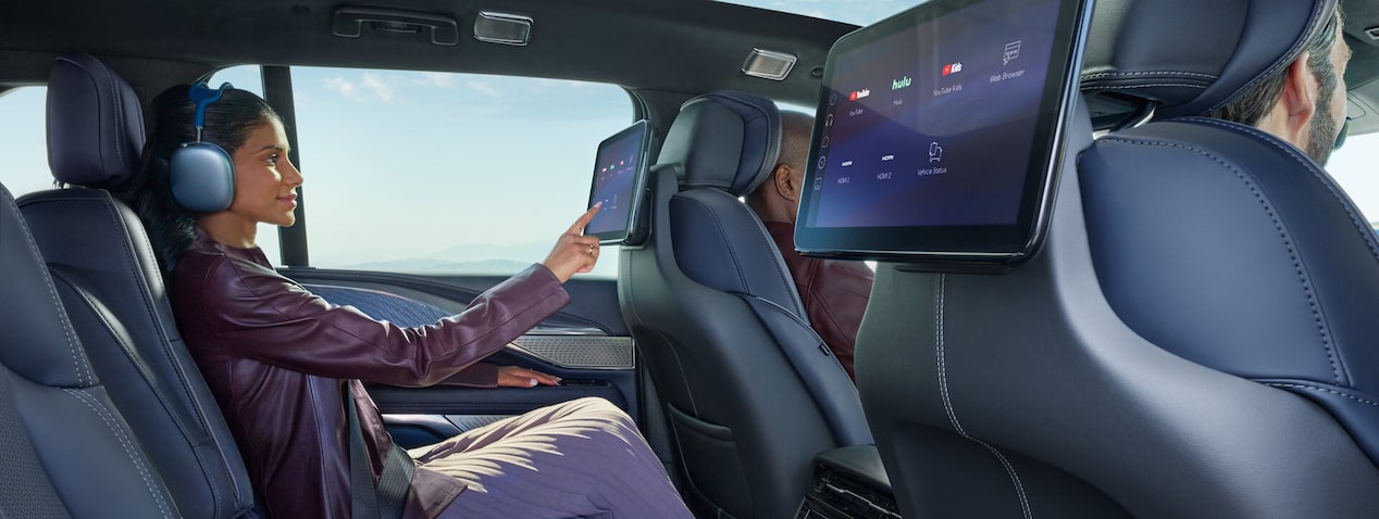 Woman pressing the OnStar button in her vehicle
