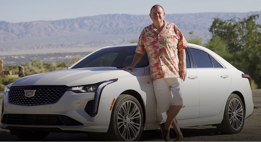 Rusty Austin standing next to his white 2021 Cadillac CT4